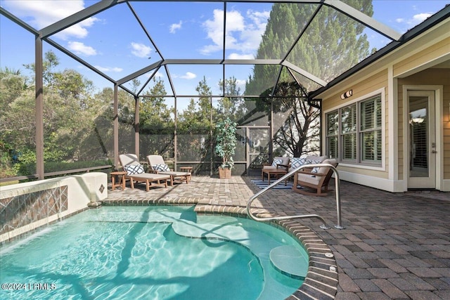 view of swimming pool with a lanai, a patio area, and pool water feature