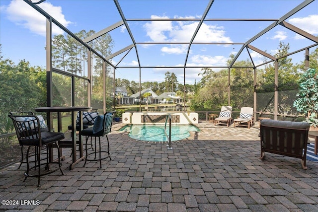 view of pool featuring a patio and glass enclosure