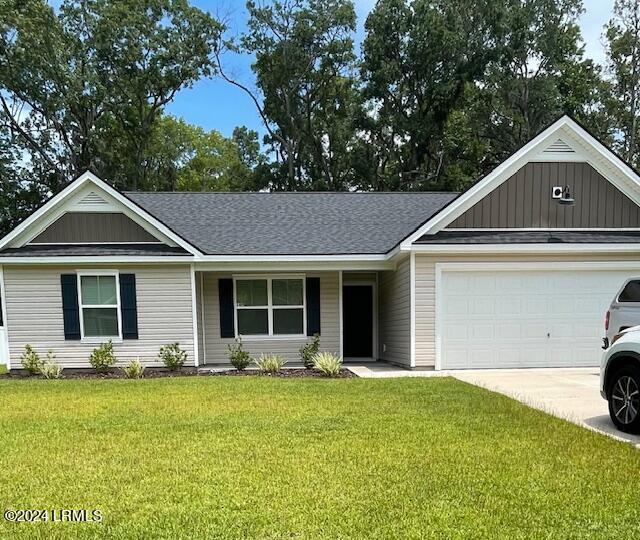 ranch-style home featuring a garage and a front yard