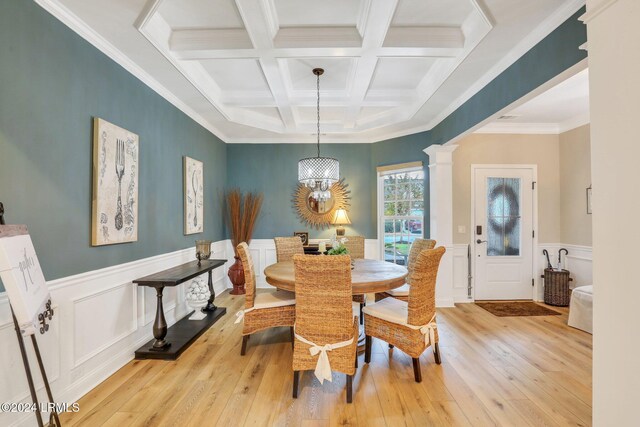 dining space featuring beamed ceiling, coffered ceiling, light hardwood / wood-style floors, and ornate columns