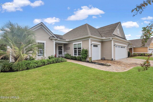 view of front of house with a garage and a front yard