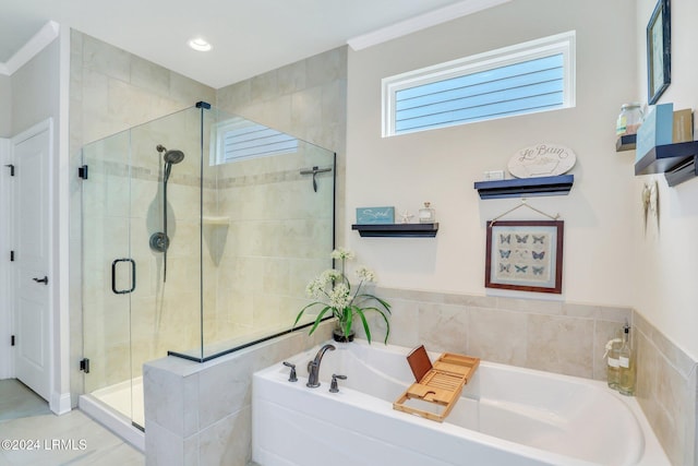 bathroom featuring crown molding and separate shower and tub