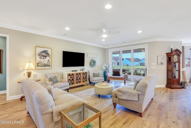 living room featuring ornamental molding, ceiling fan, and light wood-type flooring