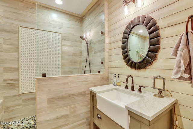 bathroom with vanity and tiled shower