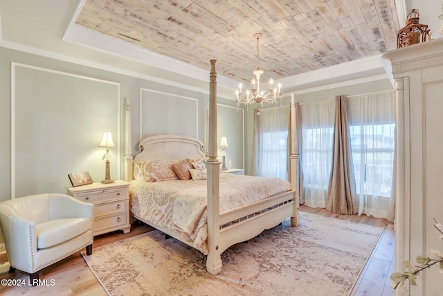 bedroom featuring wood ceiling, light hardwood / wood-style flooring, a tray ceiling, ornamental molding, and a chandelier