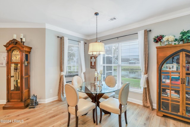 dining space featuring ornamental molding, a wealth of natural light, and light wood-type flooring