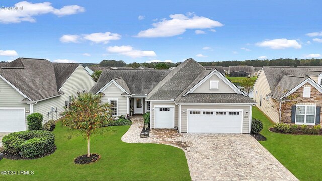 view of front of property with a garage and a front yard