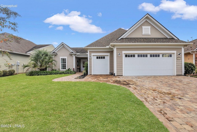 view of front of home with a garage and a front lawn