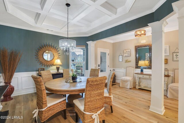 dining room featuring coffered ceiling, crown molding, beamed ceiling, and ornate columns