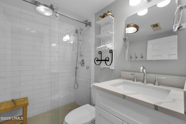 bathroom featuring vanity, toilet, and a shower with door