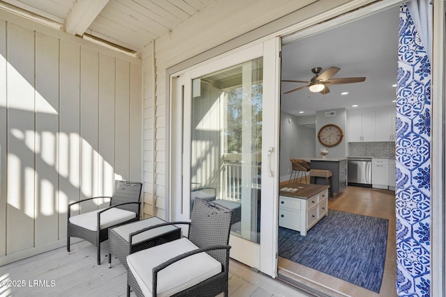 exterior space featuring beamed ceiling and ceiling fan