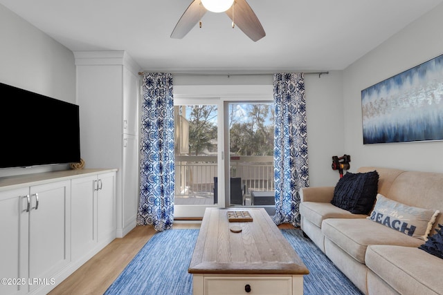 living room featuring light hardwood / wood-style flooring and ceiling fan