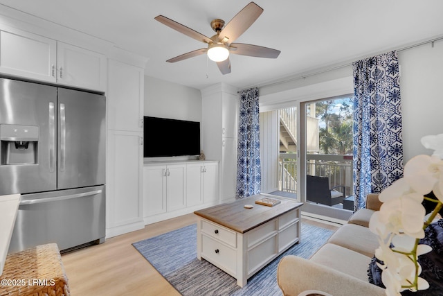 living room with ceiling fan and light wood-type flooring