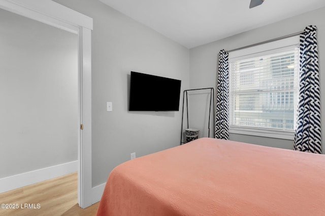 bedroom with light hardwood / wood-style floors and ceiling fan