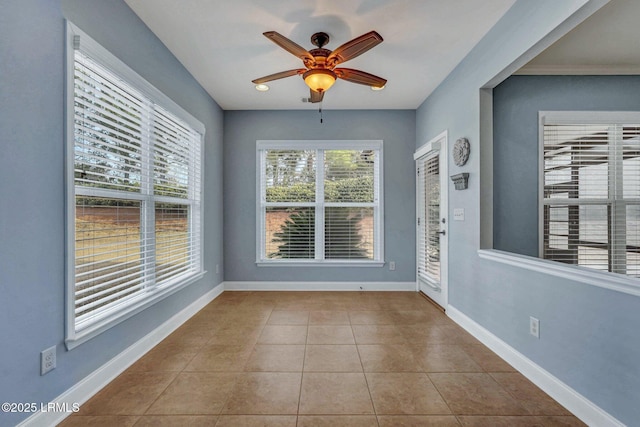 unfurnished sunroom with ceiling fan