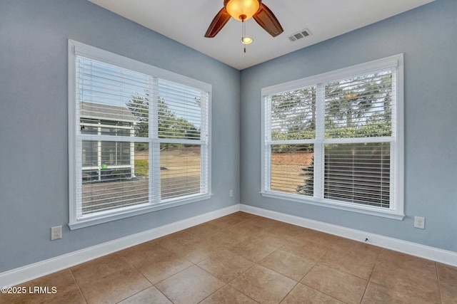 unfurnished room featuring ceiling fan, plenty of natural light, and light tile patterned floors