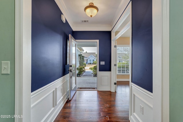 entryway with dark hardwood / wood-style flooring and crown molding