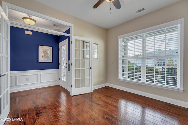 unfurnished room featuring dark hardwood / wood-style floors, ceiling fan, and french doors