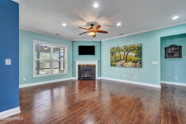 unfurnished living room featuring ceiling fan, ornamental molding, and dark hardwood / wood-style flooring