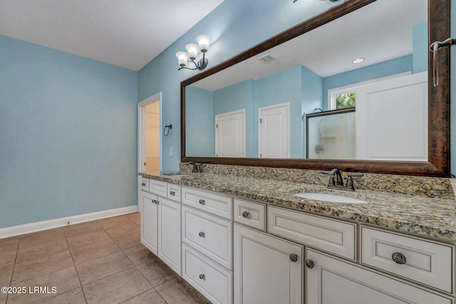 bathroom featuring an enclosed shower, vanity, and tile patterned floors