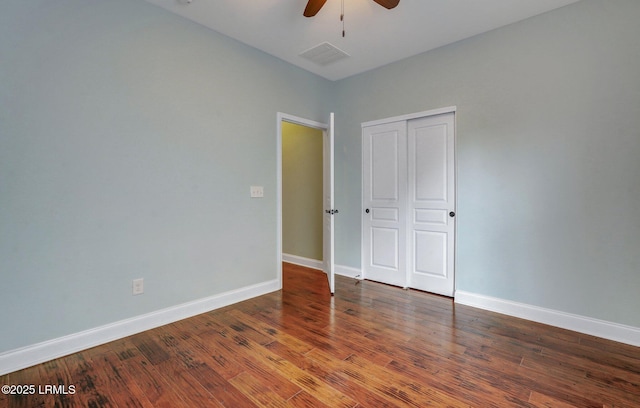 unfurnished bedroom with hardwood / wood-style flooring, ceiling fan, and a closet