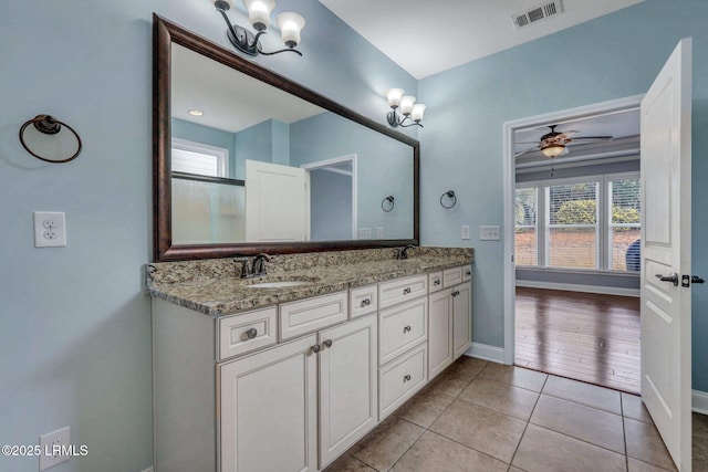 bathroom with tile patterned flooring, vanity, and ceiling fan