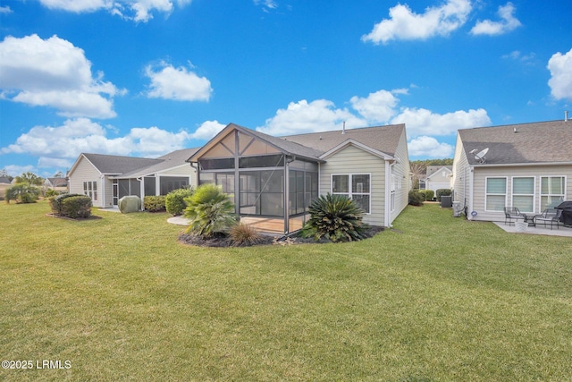 back of property with a yard, a lanai, and a patio