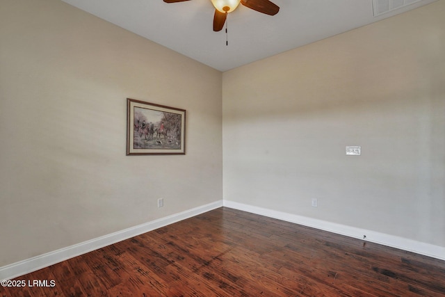 spare room with dark wood-type flooring and ceiling fan