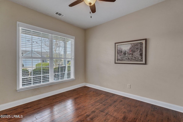 unfurnished room featuring dark wood-type flooring and ceiling fan