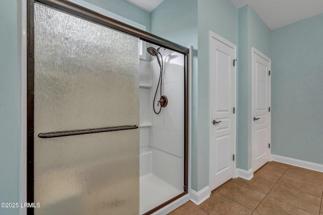 bathroom with tile patterned flooring and an enclosed shower