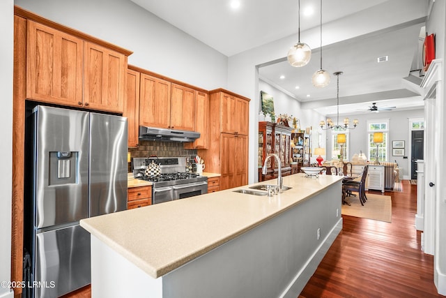 22 Harford Unit B, Beaufort, SC 29906 - kitchen featuring stainless steel appliances, under cabinet range hood, tasteful backsplash, dark wood-type flooring, and light countertops