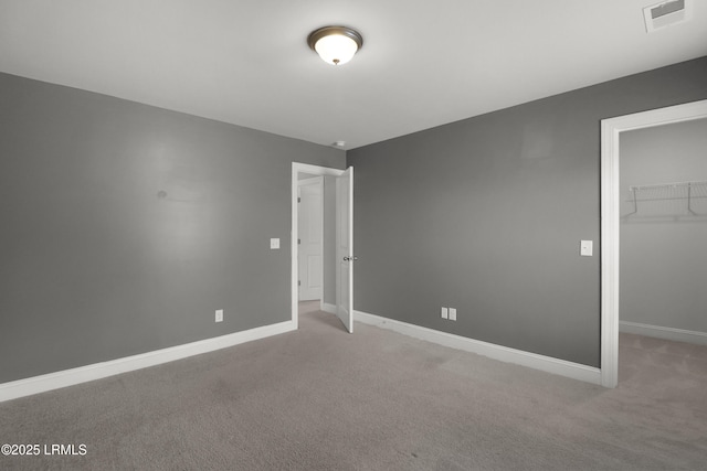 587 Hulston Landing Rd, Bluffton, SC 29909 - unfurnished bedroom featuring a walk in closet, carpet floors, and a closet