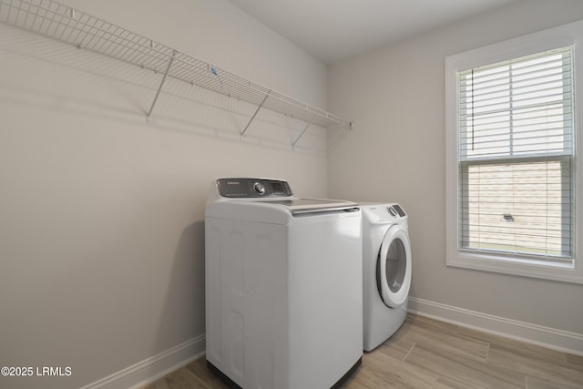 587 Hulston Landing Rd, Bluffton, SC 29909 - laundry room with washing machine and clothes dryer, plenty of natural light, and light wood-style flooring