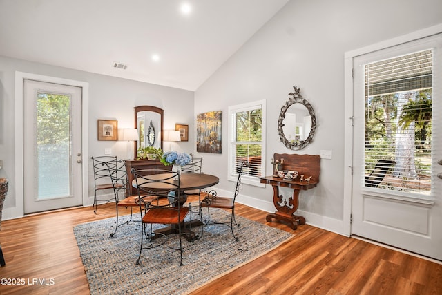 1 William St, Beaufort, SC 29907 - dining space with baseboards, high vaulted ceiling, visible vents, and wood finished floors