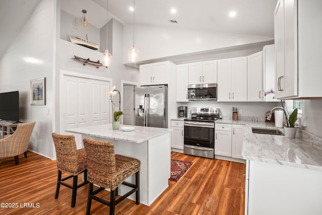 1 William St, Beaufort, SC 29907 - kitchen with a center island, stainless steel appliances, light stone counters, and a sink