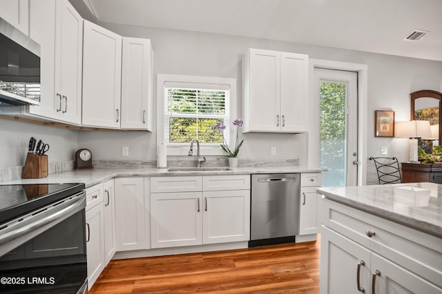 1 William St, Beaufort, SC 29907 - kitchen featuring a sink, stainless steel appliances, white cabinetry, and visible vents