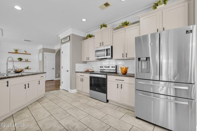 kitchen with visible vents, open shelves, ornamental molding, a sink, and appliances with stainless steel finishes