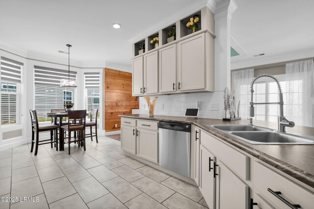 kitchen with crown molding, a sink, decorative backsplash, and dishwasher