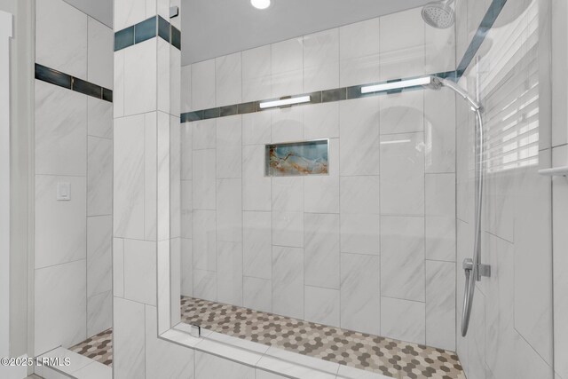 full bathroom featuring recessed lighting and a tile shower