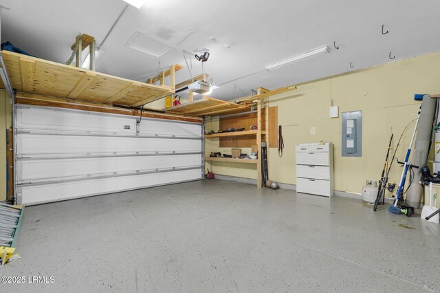garage featuring baseboards, a garage door opener, and electric panel