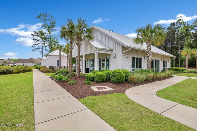 view of side of property with a lawn and fence
