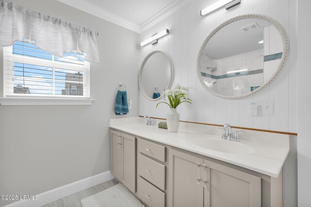 full bathroom featuring a sink, ornamental molding, double vanity, and visible vents