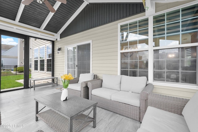 exterior space featuring an outdoor hangout area, fence, and a ceiling fan