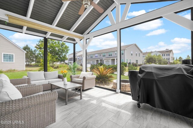 sunroom / solarium featuring an outdoor hangout area, ceiling fan, and a residential view