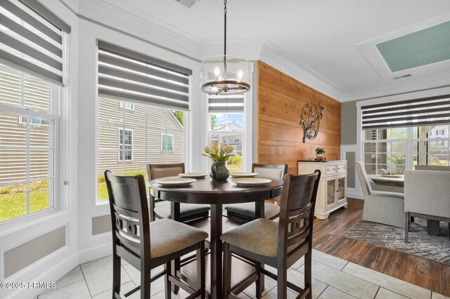 dining area with crown molding, a chandelier, light tile patterned floors, and visible vents
