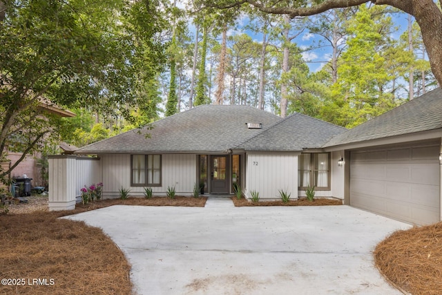 72 Cypress Marsh Dr, Hilton Head Island, SC 29926 - view of front facade featuring driveway, a garage, and a shingled roof