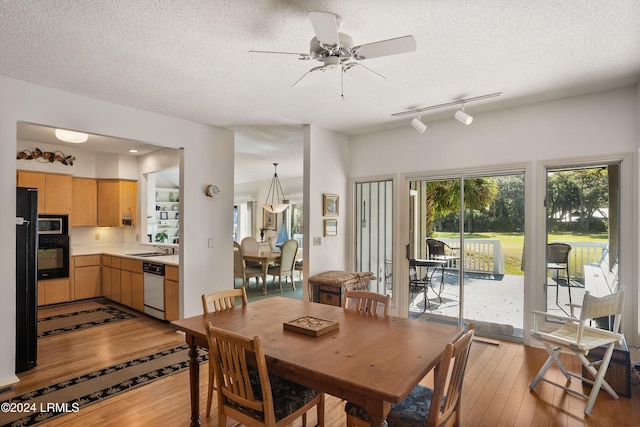 dining room with ceiling fan and a textured ceiling