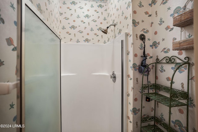 bathroom featuring a shower with door