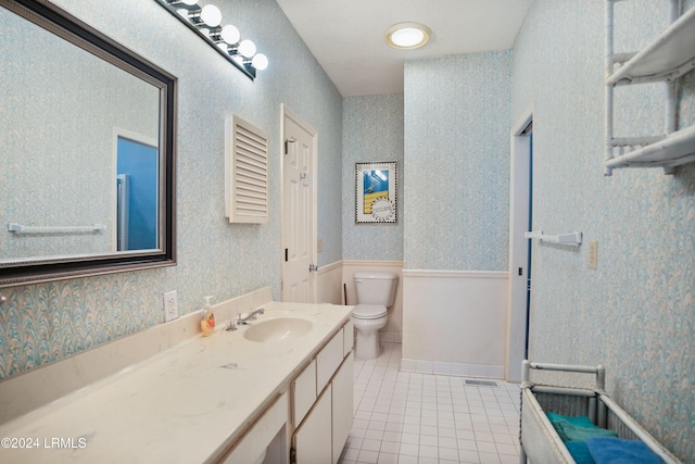 bathroom with vanity, toilet, and tile patterned flooring