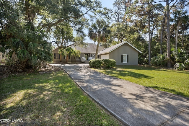 ranch-style home with a garage and a front yard